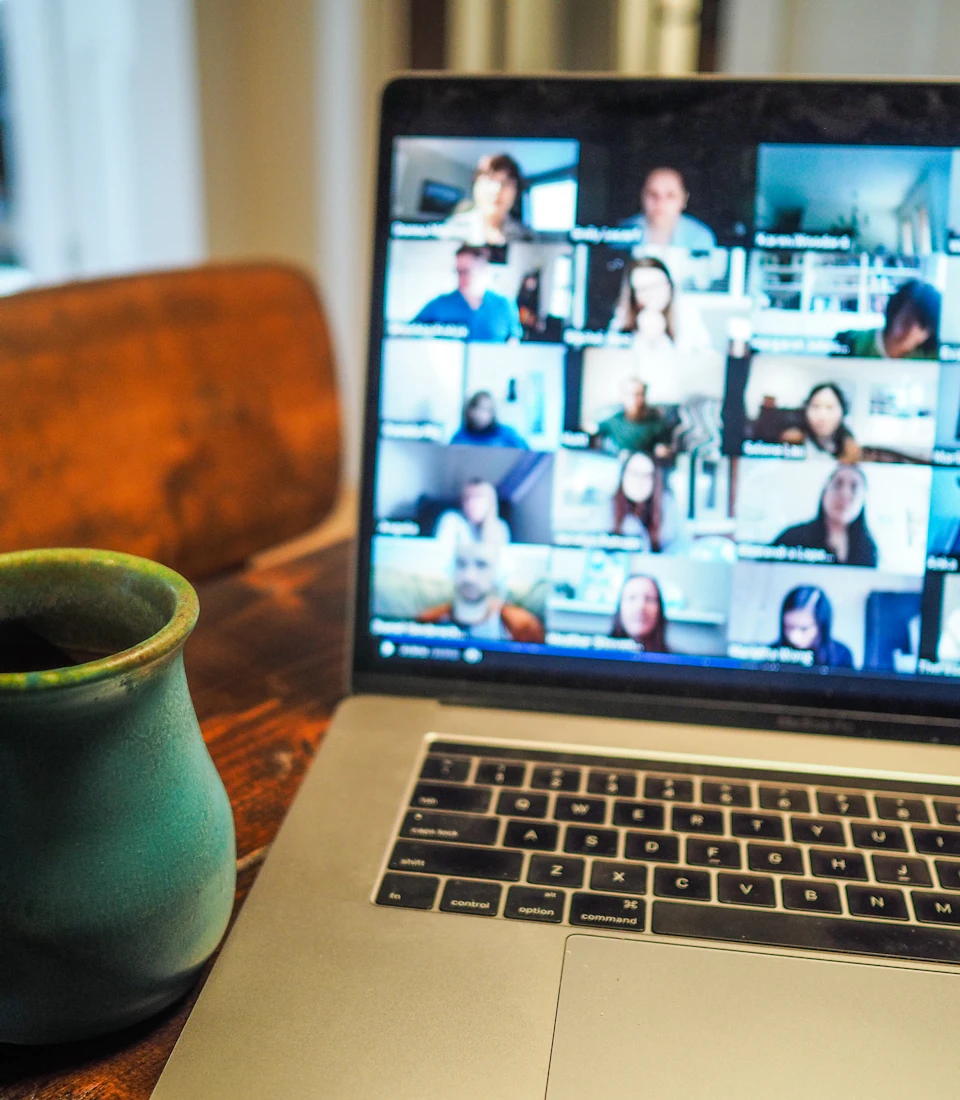 A laptop showing many people in an online session
