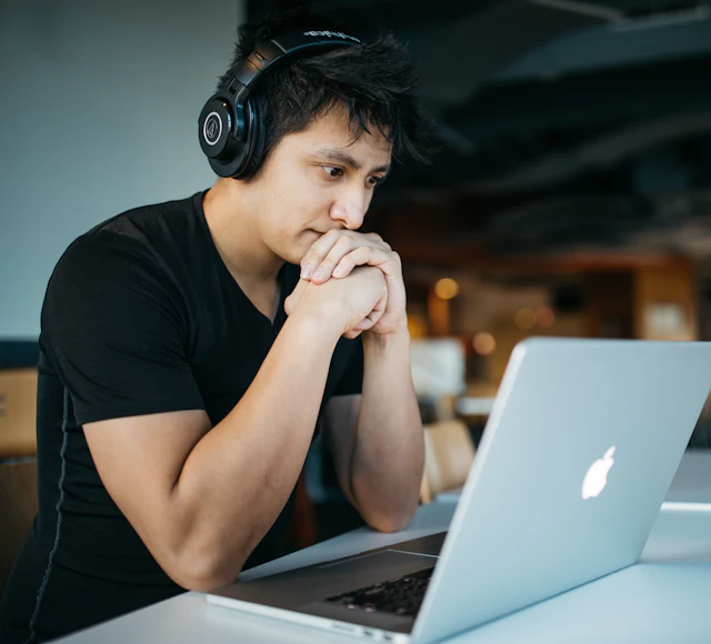 A student studying alone at his laptop